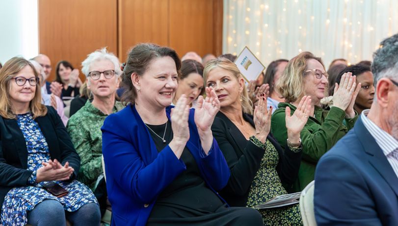 Busy room full of people smiling and applauding at the 2024 Health & Wellbeing Awards ceremony