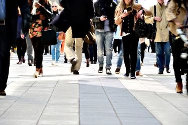 A crowd of people walking down a busy street.