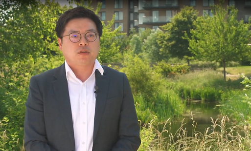 Michael Chang, an Asian man with short black hair. He wears glasses and a navy suit.