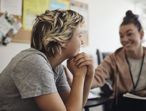 Photo of a healthcare worker performing a public health intervention with a teenager