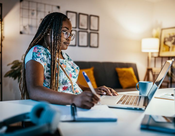 Woman at her laptop taking online courses through RSPH Learn